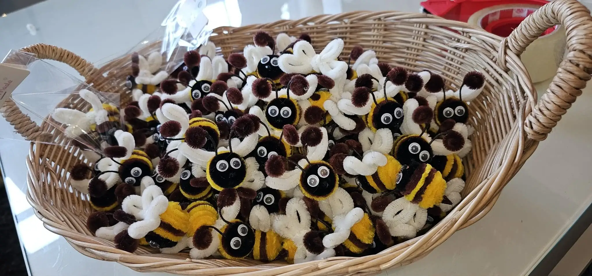 Basket of handmade pipe cleaner bees ready for shipping worldwide